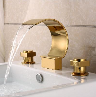 China Contemporary Hotel Bathroom Double Handles Faucet Brass Deck Mounted Waterfall Spout Gold Basin Faucet for sale