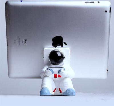 China New Universal Cell Phone Holder Resin Astronauts Lazy Phone Holder Desktop Display Stand Shown for sale