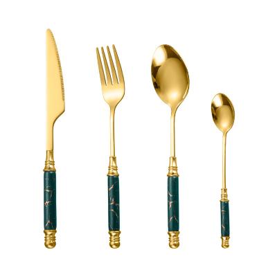 China Viable Antique Ceramic Handle 4 Piece Set Of Luxury Stainless Steel Gold Dinnerware Set for sale