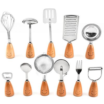 China 2022 New Design Stainless Steel Kids Kitchen Stocked Utensil Set 11pcs Smile Beech Wood Handle Kitchen Accessories for sale