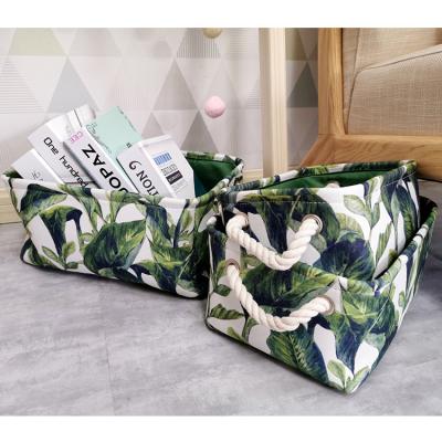 China Decorative Handles Storage Basket Natural Green Leaves Storage Basket Fabric Desktop Storage Baskets for sale