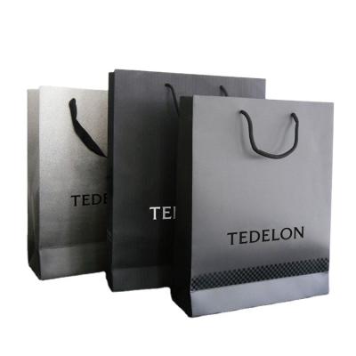 China Cheap Custom Printed Luxury Retail Paper Shopping Bag,Low Cost Paper Bag,Color Paper Bag Supplier à venda