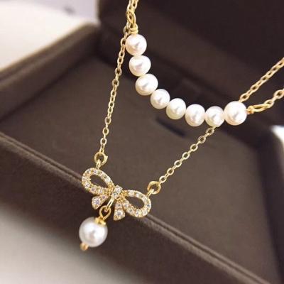 China TRENDY Korean Sweet 14K Gold Plated Brass Inlaid Zircon Double Layer Bowknot Pearl Necklace Jewelry Natural Freshwater Dangle Women for sale