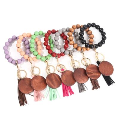 China Wood Personalized Monogram Wooden Keychain Wooden Stretch Key Chain Tassel Bead Disc Tassel Leather Bracelets Keychains for sale