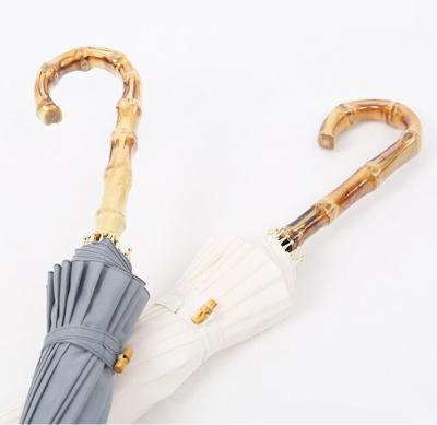 China Modern Luxury J Handle 16 Rib Curved Bamboo Stick Solid Color Upright Umbrella for sale