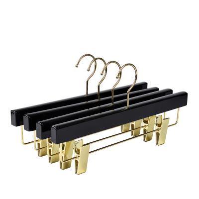 China Adjustable Inspring Customized Wooden Pant Hangers With Gold Clips for sale