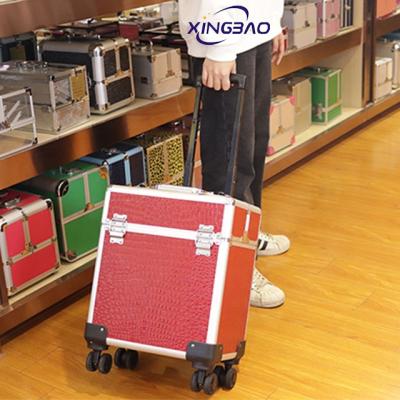 China Professional Trolley Luggage PVC Red Skin Makeup Trolley Case On Wheels for sale