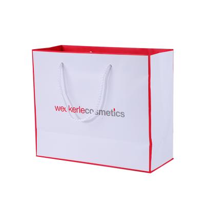 China Logo Printed Glossy Luxury Drawstring Recyclable Custom Gift Paper Cosmetic Shopping Bags for sale