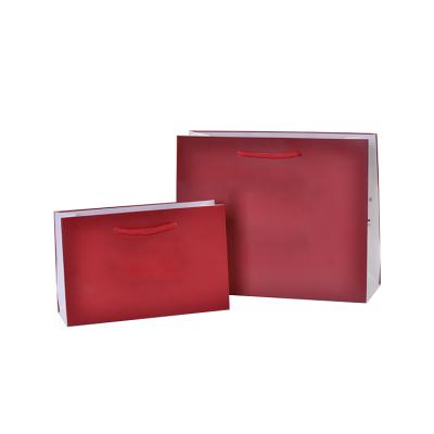 China Recyclable Custom Red Logo Drawstring Luxury Bulk Party Gift Paper Packaging Bags With Handles for sale