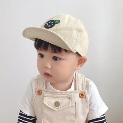 China Kids Hat Solid Color Face Boy Girl Sports Wholesale Flat Smile Flat Along Hip Hop Baby Baseball Cap for sale