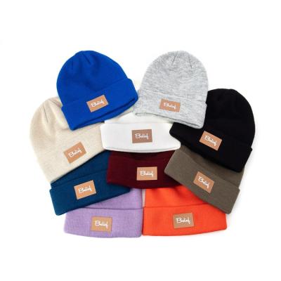 China Adults JOINT Acrylic Winter Outdoor Warm Leather Label Knit Beanies Hats for sale