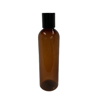 China Non Spill Plastic Bottles PET Amber Cosmo Oval Bottles With Black Pumps for sale