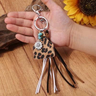 China Key Chains Retro Geometric Cow Shape Handmade Key Ring Leather Tassel Turquoise Sunflower Pendant Key Chain for sale