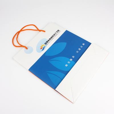 China Recycled Materials Wholesale Eco - Friendly White Cardboard Packaging Paper Bags With Handle for sale