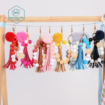 China Viable Personalized Silicone Leopard Beaded and Wood Beaded Bracelet Key Chain with Tassel and Puff for sale