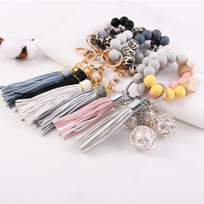 China Sustainable Soft Silicone And Wooden Bead Bracelet Bangle With Tassel Bracelet Key Chain Ring for sale