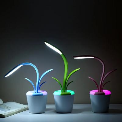 China Modern Creative 360-degree bendable flexible Clivia desk lamp with colorful light silicone reading lamp for sale