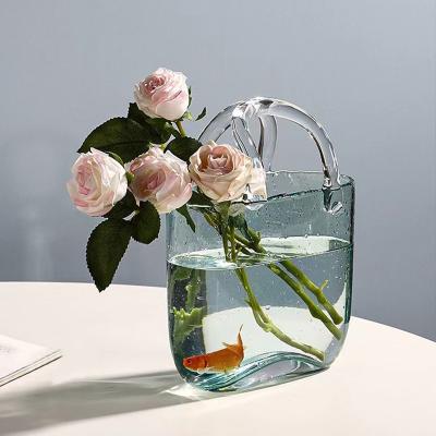 China Wedding Home Decor Modern Glass Handbag Vase Perfect for Fresh Flowers Goldfish for sale