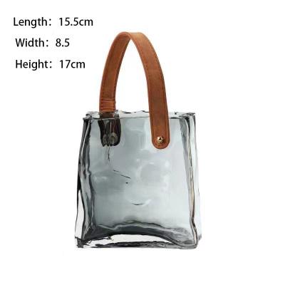 China Einzigartige klare Handtasche Blumenvase Handtasche Glasvase Dekor für das Home Office zu verkaufen