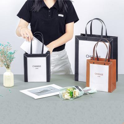 China Luxury Shopping Tote Bag Wholesale Custom Shopping Recyclable Exquisite Black Clothing Tote Bag Gift Fashion Shopping Bag With Logos for sale