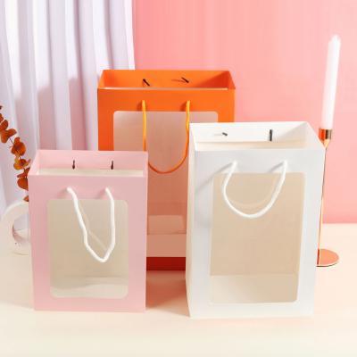 China Handmade Environmental Friendly Clear Window Pockets Paper Bag Rope Handle Orange Light Pink Gift Bags Paper Custom Logo With Windows for sale