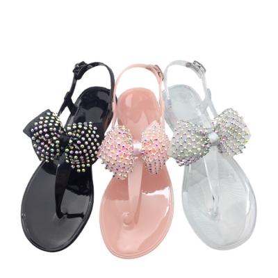 China Fashion trend multicolor bow fabric summer diamond crystal sandals for women outdoor white fashion PVC beach leisure flat shoes for sale