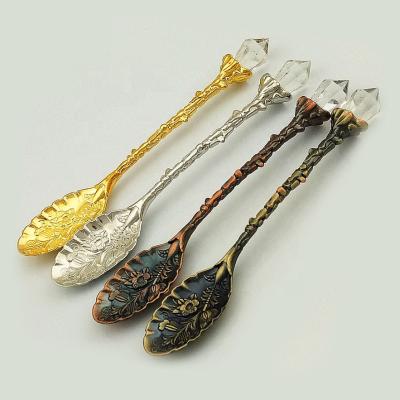 China Viable Artificial Crystal Head Pattern Vintage Tea Spoon Coffee Scoops Design Festival Party Spoon Cutout Scoops for sale