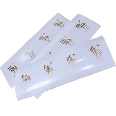 China Custom Stamp Waterproof Logo Transparent Adhesive Sticker Golden Label for sale