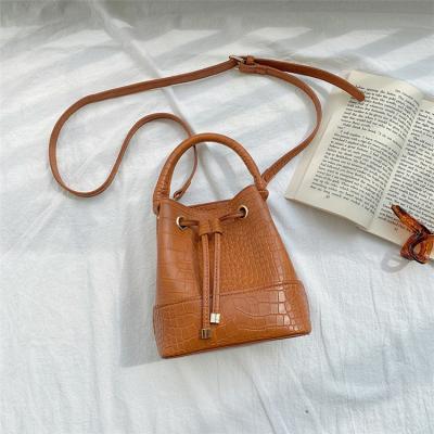 China Fashion crocodile pattern winter women handbags vegan leather bucket bag with handle and long strap for sale