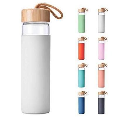 China 2022 Viable Friendly Glass Water Bottle Inside Filter Bamboo Lids Unbreakable Glass Water Bottle With Bamboo Lid for sale