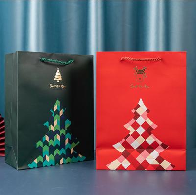 China Low Price Recyclable Color Printed Pattern Christmas Paper Gift Bag With Handles And Custom Printed Logo for sale