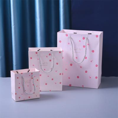 China Lovely Reasonable Different Size Cardboard Recyclable Customized Printing Paper Gift Bag With Handles For Girls for sale