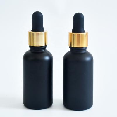 China Cosmetic In Stock 30ml Black Frosted Glass Dropper Bottle Essential Oil Bottle With Gold Cap for sale