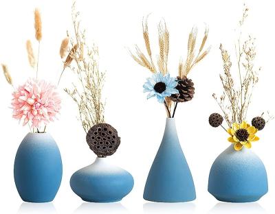 China Modern Decorative Ceramic Bottle Bud Vase Set Reed Diffuser Flower Vases Small For Living Room Wicker Blue White Vase for sale