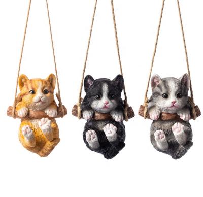 China Animal Figurine Art Decorative Hanging Cat Resin Statues Cat Sculpture Outdoor Patio Ornament Unique Cute Swing for sale