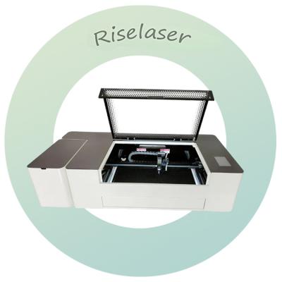 China 60w Co2 Mini-Laser-Gravurmaschine Desktop vollständig geschlossen für Holzakryl zu verkaufen