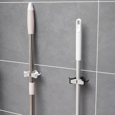 China Kitchen Multifunctional Bathroom Finishing Rack No Trace Mop Clip Mop Rack With Creative Powerful Hook Storage Holder for sale