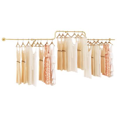 China Clothes Shop Nordic Simple Poles Gold Metal Pipe Display Clothes Racks Wall Mounted Dress Wall Clothing Racks For Stores Boutique for sale