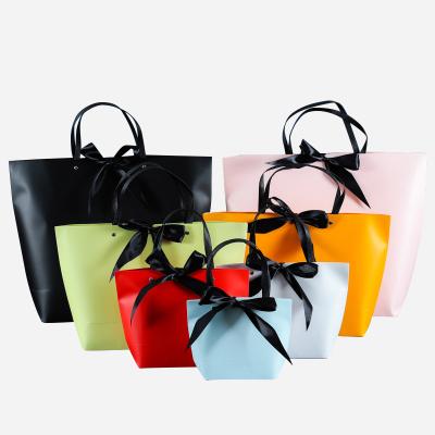 China Luxury Apparel Jewelry Boutique Retail Customized Your Logo Gift Small Carry Paper Shopping Bag With Bow Tie Ribbon Handle for sale