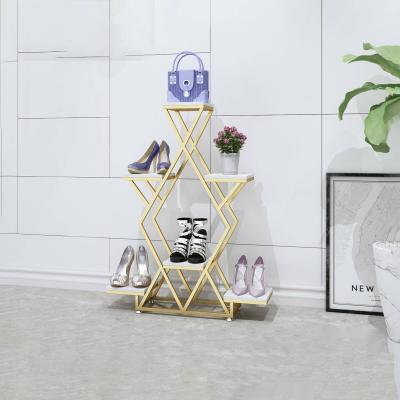 China Stores Retail Customized High End Luxury Interlocking Clothing Store Metal Worktop Display Racks Table Shoes Flower Stand for sale