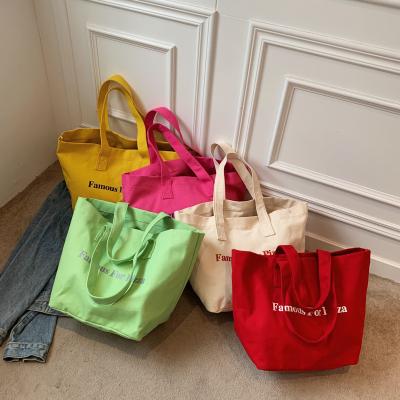 China Other new 2022 large capacity single-shoulder alphabet printing canvas bucket bag travel student custom logo single cloth bag for sale