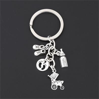 China Lovely Cute Souvenir 1Pc Baby Carriage Milk Bottle Key Chain Shoes Mother Cradling Theme Key Chain Mother's Day Souvenir Jewelry E2690 for sale