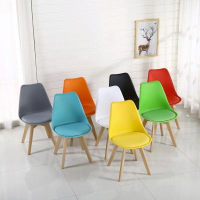 China Comfortable High Quality Home Furniture Stackable PU Elastic Seat Dining Plastic Chair With Solid Beech Wood Legs for sale