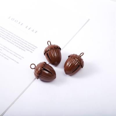 China Christamas decoration design new in Christmas pinecone bell brown iron tassel bell decor running bell for sale