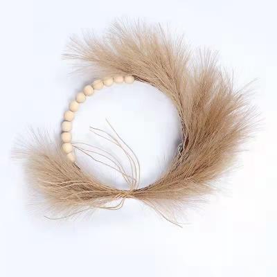 China Hot Sale Amazon Wedding Decoration Fake Pampas Grass Wooden Bead New Braid Wooden Bead Artificial Pompas Grass Garland For Door Home Decoration for sale