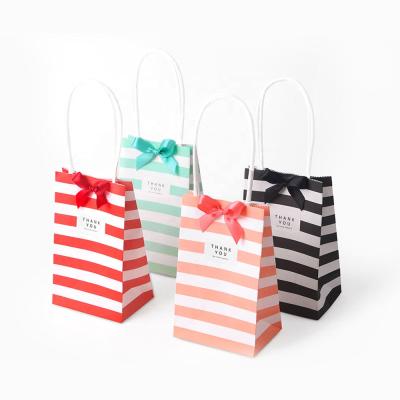 China Small Recycled Materials Stripe Paper Gift Candy Packaging Bag Bags With Handle Pouch for sale