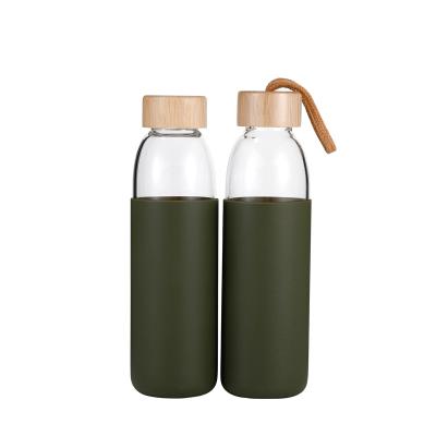 China Viable Wholesale Free Samples High Borosilicate Glass Water Bottles With Bamboo Lid With Christmas Bottle Cover for sale