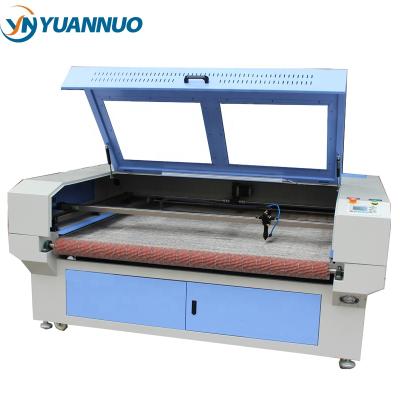 China Laser CUTTING Double Heads Cloth Circle Laser Cutter YN 1610 with Automatic Felt Fabric Cloth Leather Feed Price for sale