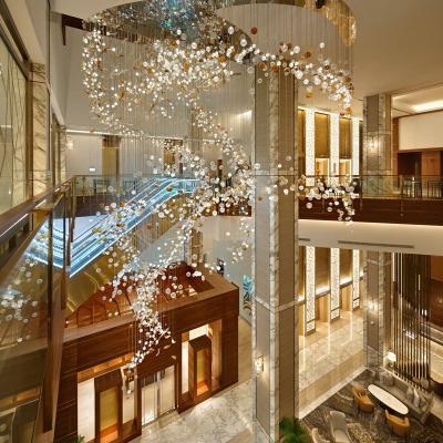 China Modern Zhongshan Customize Creative Long Fish Stairs Spiral Ball Chandelier Shopping Mall for sale