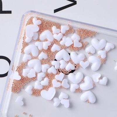 China Festival Holiday Finger Nail Art DIY Decoration Oosi Accessories Beads Stainless Steel Ball Resin Heart Decoration Nail Art 3D Design For Nail Salon Supplies for sale